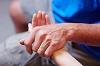 A photo of a patient's and a care provider's hands
