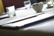 alt="Pencil Resting on Corporate Meeting Notepad"