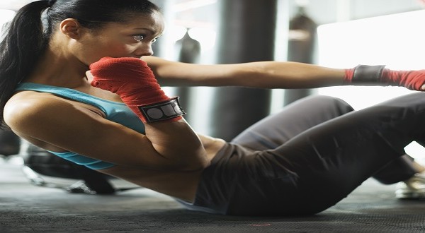 Woman doing crunches in gym