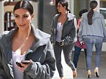 UK CLIENTS MUST CREDIT: AKM-GSI ONLY\nEXCLUSIVE: Kim Kardashian was spotted out walking in Beverly Hills, CA on Monday afternoon, unusually dressed down for one of her outings. The reality starlet donned a simple white wifebeater, skinny jeans and an oversized men's hoodie, carrying only her phone.\n\nPictured: Kim Kardashian\nRef: SPL993172  060415   EXCLUSIVE\nPicture by: AKM-GSI / Splash News\n\n