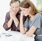 BD2FN0 Worried couple at table paying bills