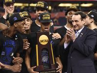Duke Blue Devils celebrate with the NCAA trophy on the podium after defeating the Wisconsin Badgers 68-63 in the 2015 NCAA Men's Division I Championship game at Lucas Oil Stadium.