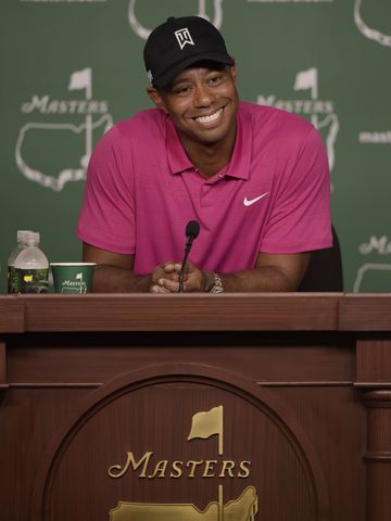 Four-time Masters champion Tiger Woods speaks with