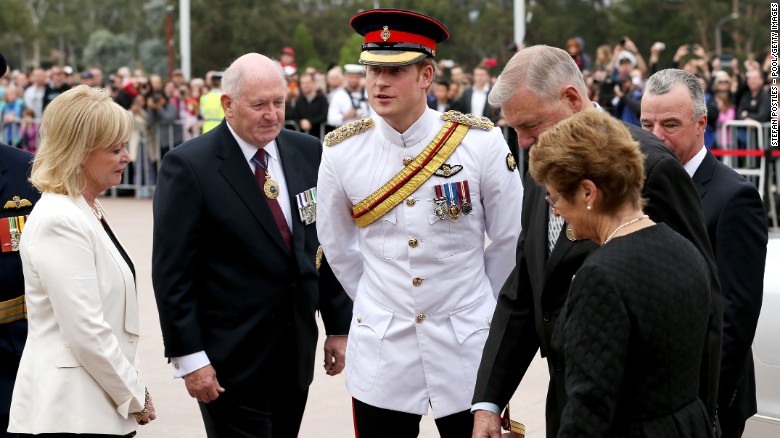 Prince Harry is greeted by Governor-General Sir Peter Cosgrove, second left,  and Chairman of the Council of the War Memorial Ken Doolan, third right, during a visit to the Australian War Memorial on Monday, April 6, in Canberra, Australia. Prince Harry, or Captain Wales as he is known in the British Army, will end his military career with a monthlong secondment, or temporary assignment, to the Australian Defence Force in barracks in Sydney, Perth and Darwin. The prince has grown up in the public eye. Take a look back as the young prince matured into adulthood: 